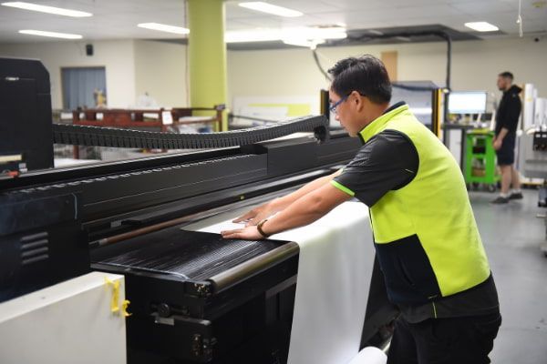 A professional doing wide format printing at a company serving Sydney