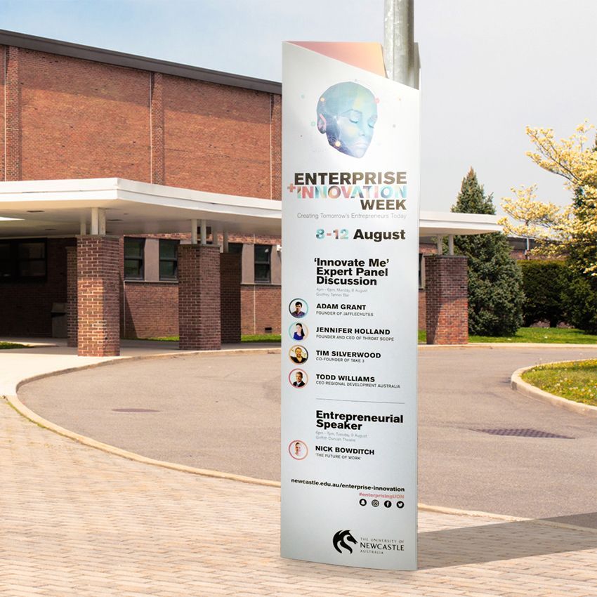 A sign for enterprise innovation week is outside of a building