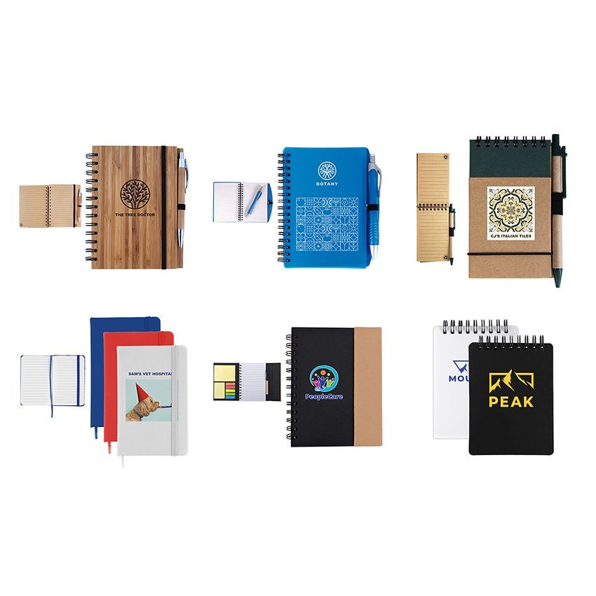 A bunch of different types of notebooks are sitting on top of each other on a table.