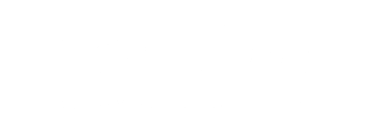 A dark silhouette of a lone figure walking across a vast, barren landscape under a bright, clear sky.