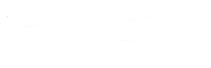 A close-up of a brown, weathered hand holding a small, vibrant green sapling rooted in dark soil.