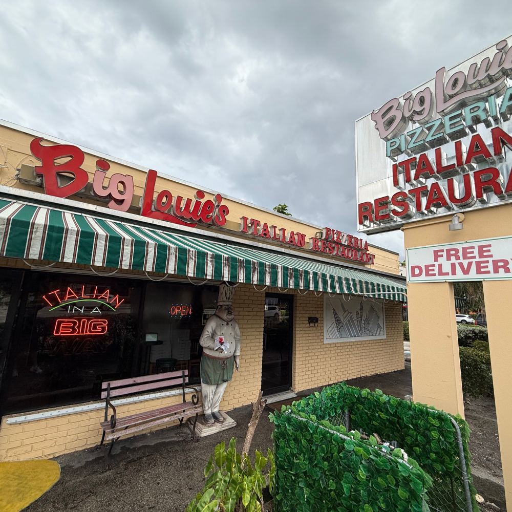 Big Louie’s Pizzeria façade with green and white awning