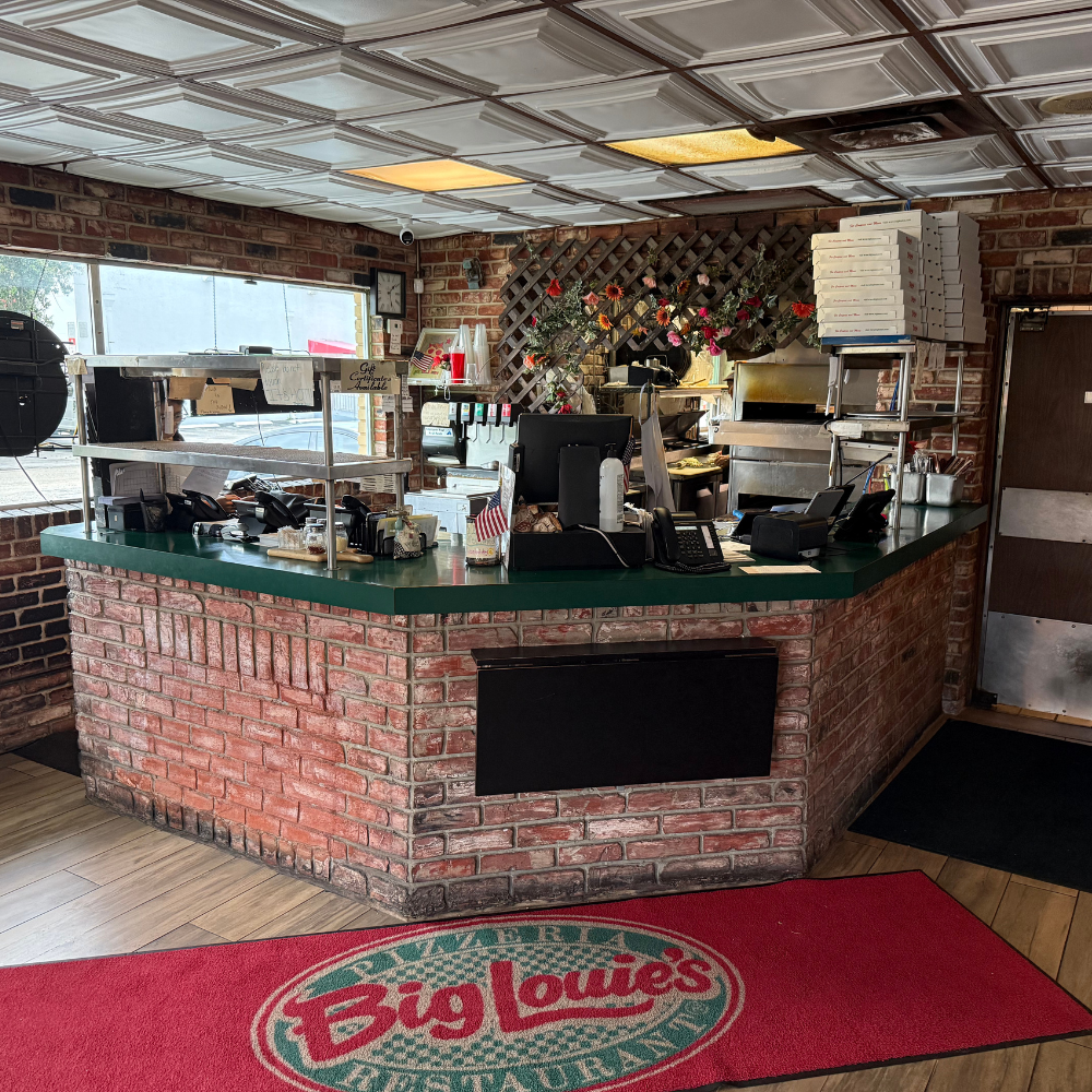 Big Louie’s Pizzeria counter with brick base and green top