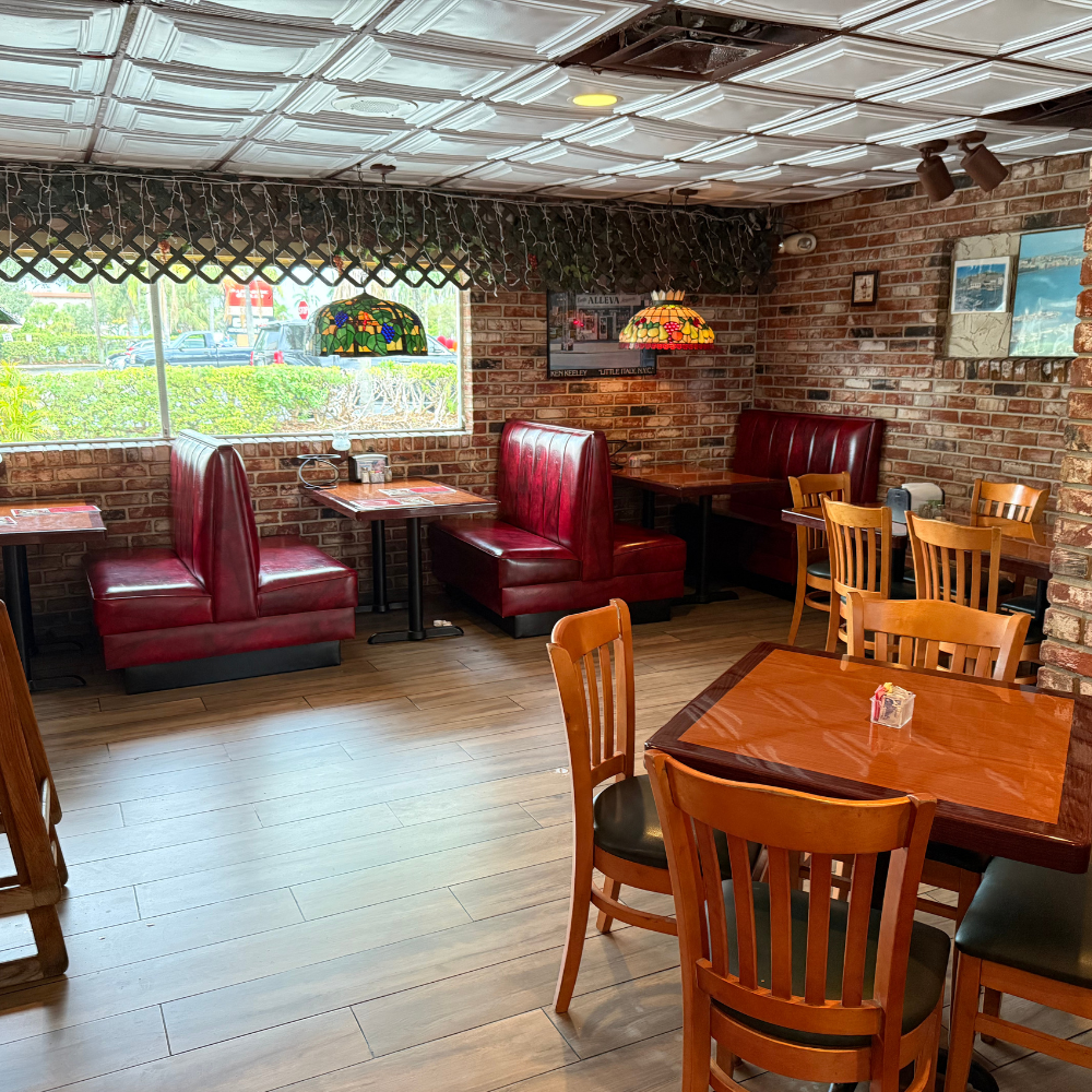 Big Louie’s Pizzeria dining area with brick walls and décor
