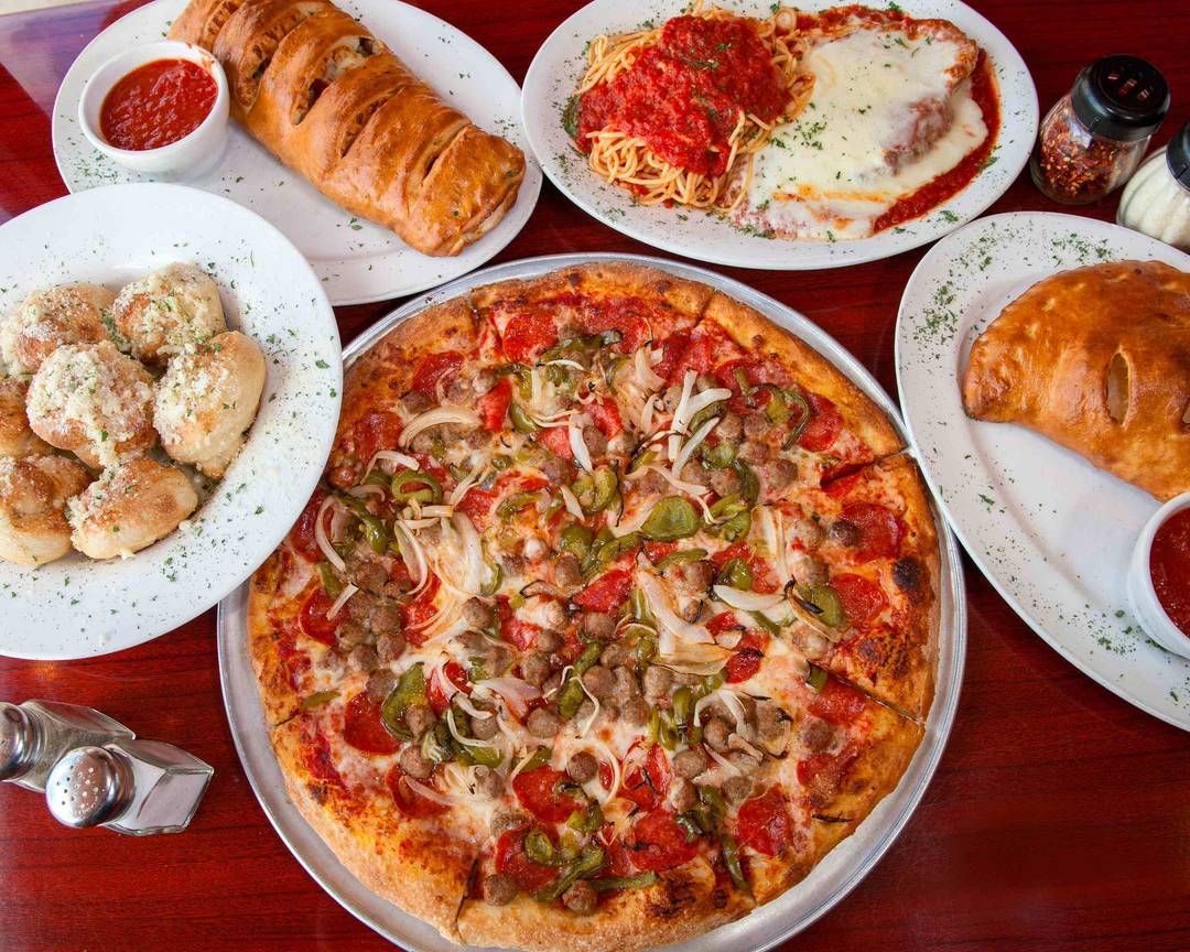 Feast of pizza, pasta, and calzone at Big Louie’s Pizzeria