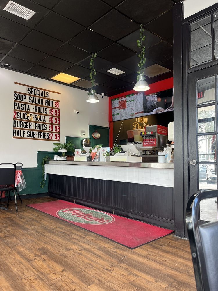 Big Louie’s Pizzeria dining area with counter and ceiling lights