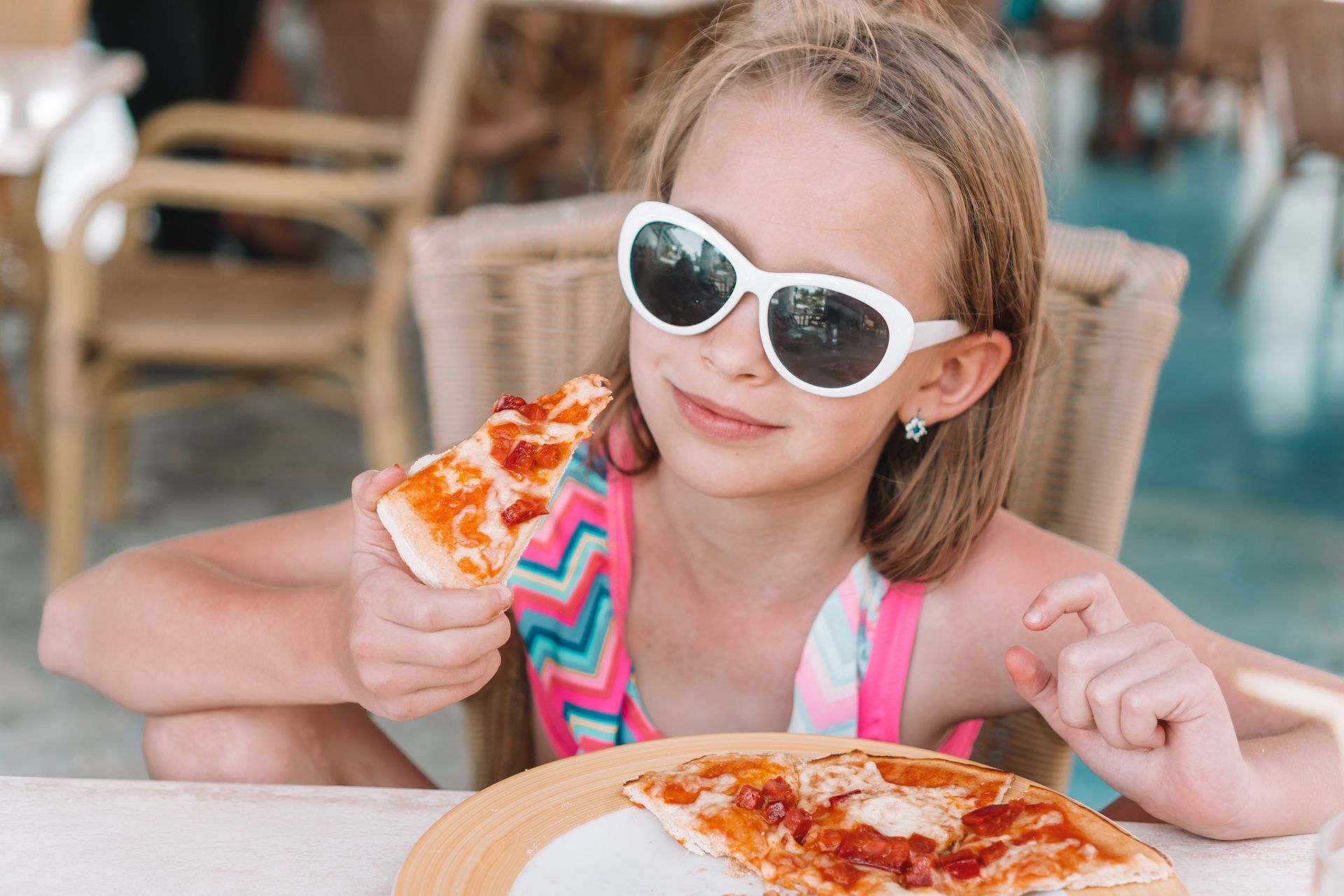 little girl eating pizza