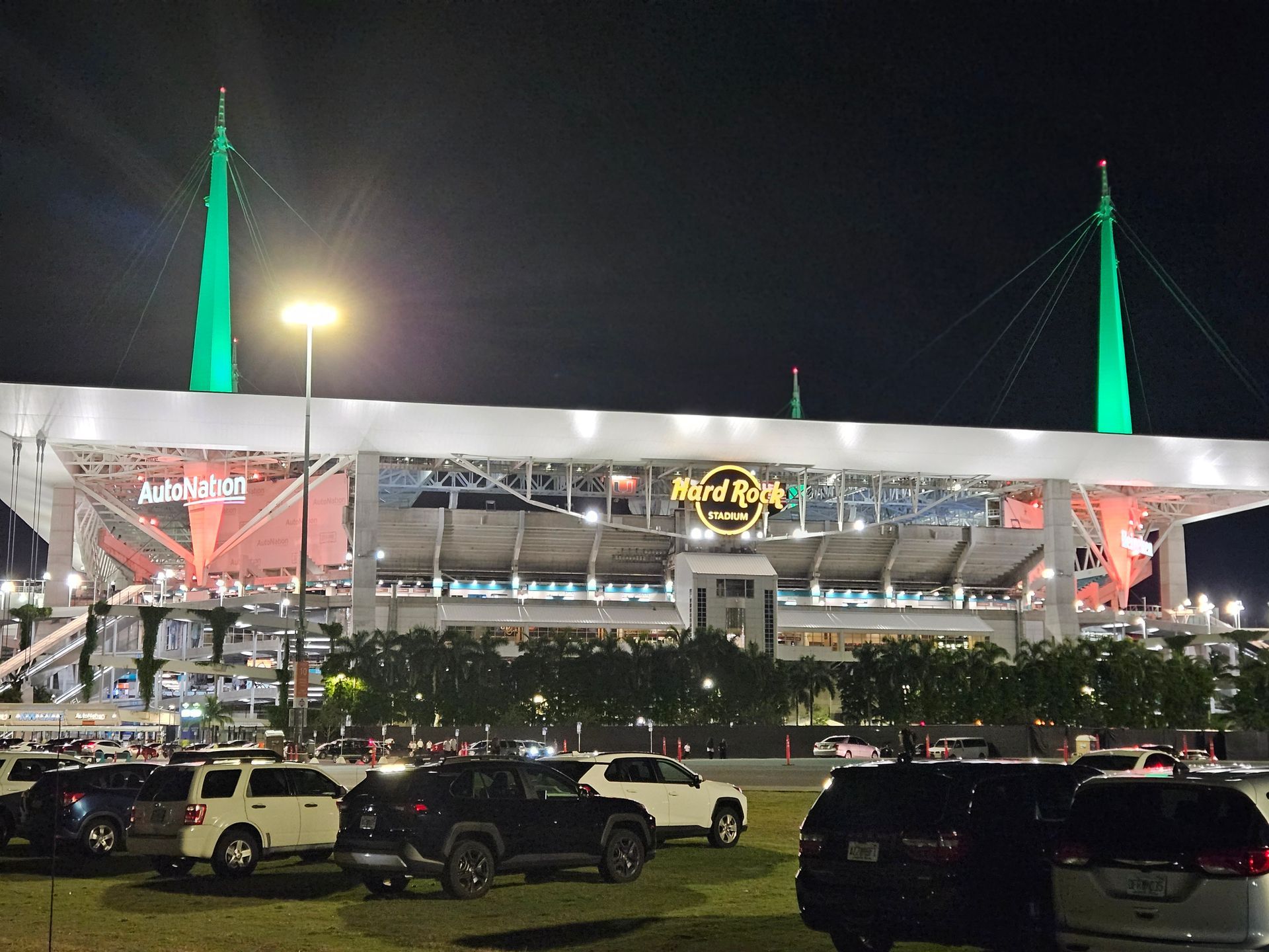 Cars are parked in front of a building that says hard rock