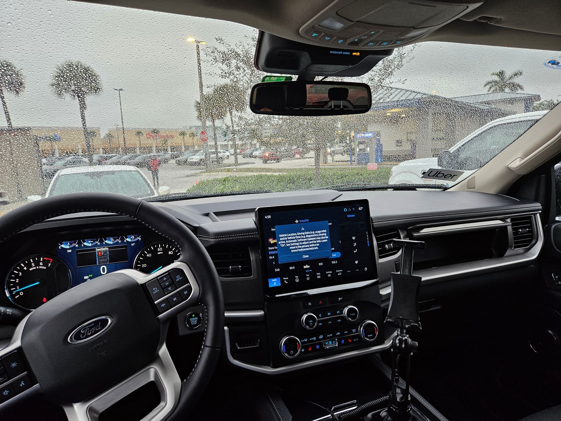 The inside of a ford truck with a tablet on the dashboard.