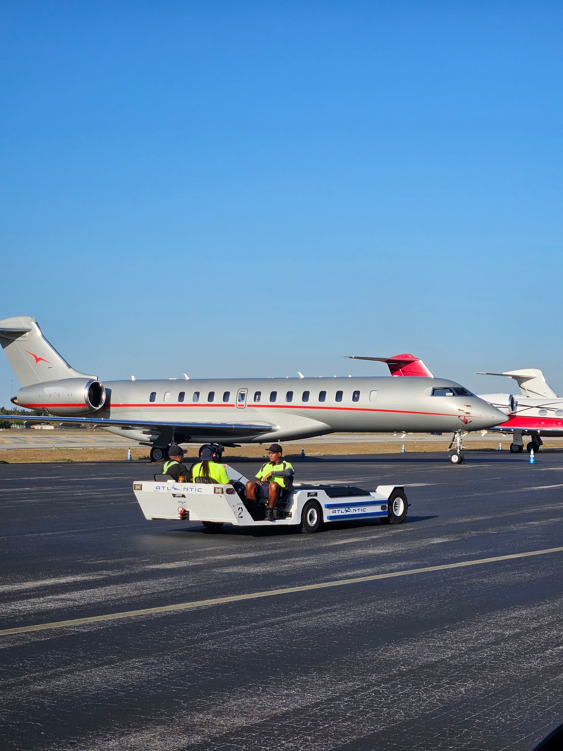 A plane is being pulled by a tow truck on a runway