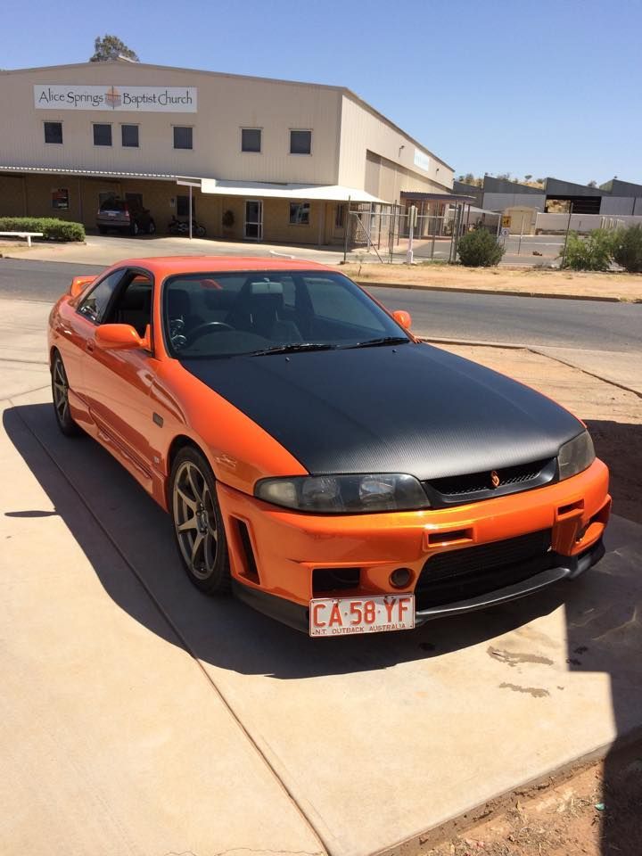 An Orange Car With a License Plate — Alice Crash Repairs In Ciccone, NT
