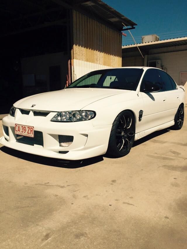 A White Car is Parked in Front of a Building — Alice Crash Repairs In Ciccone, NT