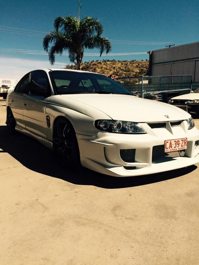 A White Car With a License Plate — Alice Crash Repairs In Ciccone, NT