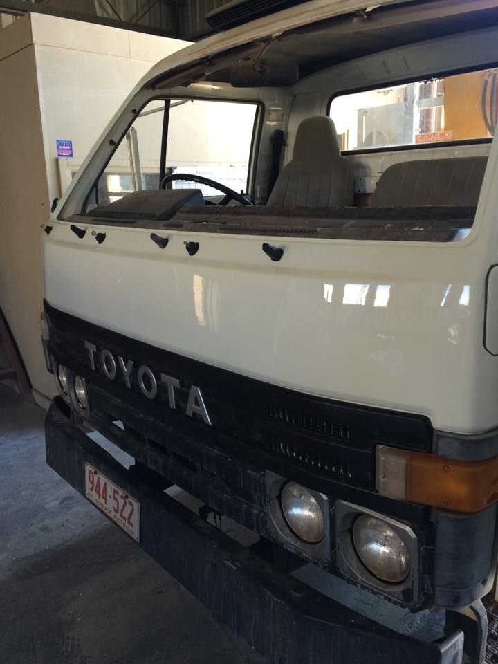 A White Toyota Truck is Parked in a Garage — Alice Crash Repairs In Ciccone, NT