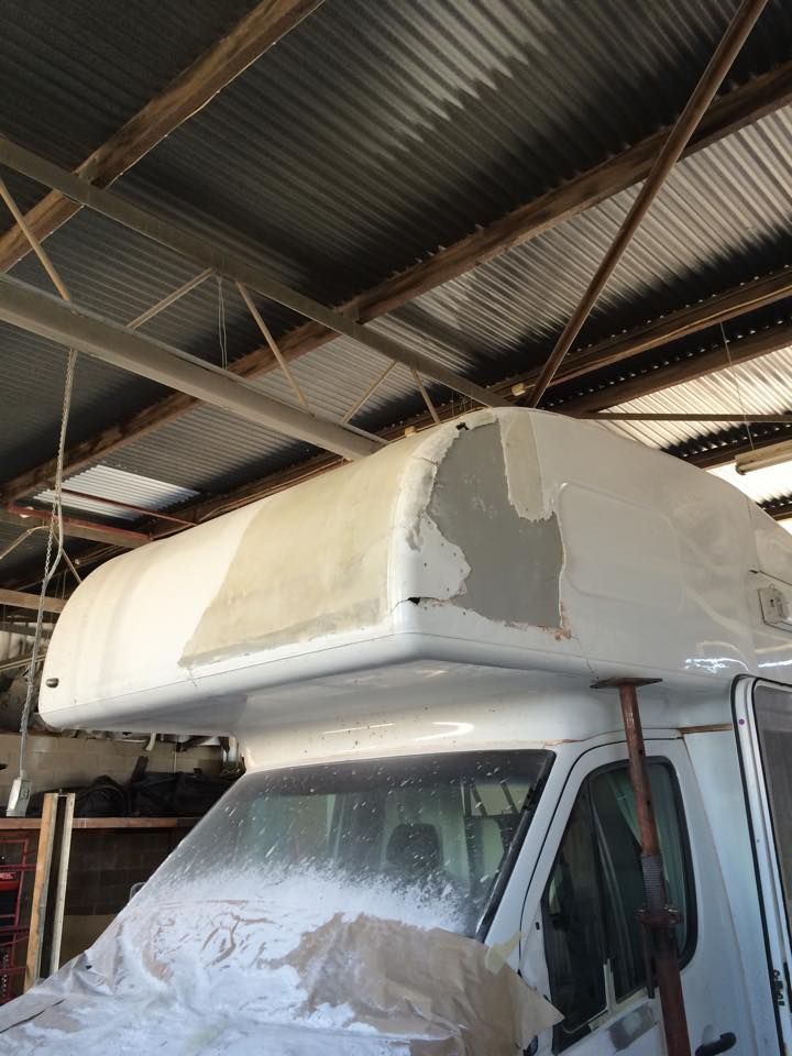 A White Van With a Canopy on Top of It is Sitting in a Garage — Alice Crash Repairs In Ciccone, NT