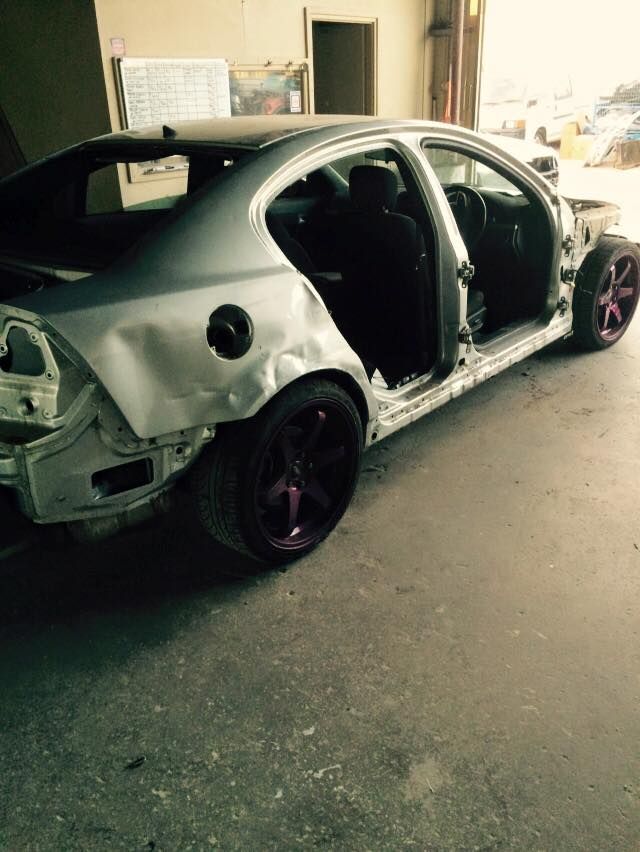 A Silver Car With Purple Wheels is Parked in a Garage — Alice Crash Repairs In Ciccone, NT