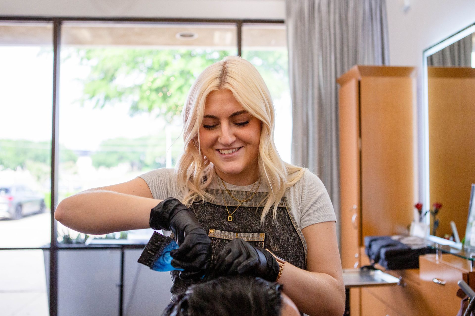 A woman is getting her hair dyed in a salon. Freelance Photographer Sarah Rosie captures the personality of your business through impactful imagery that boosts your brand!