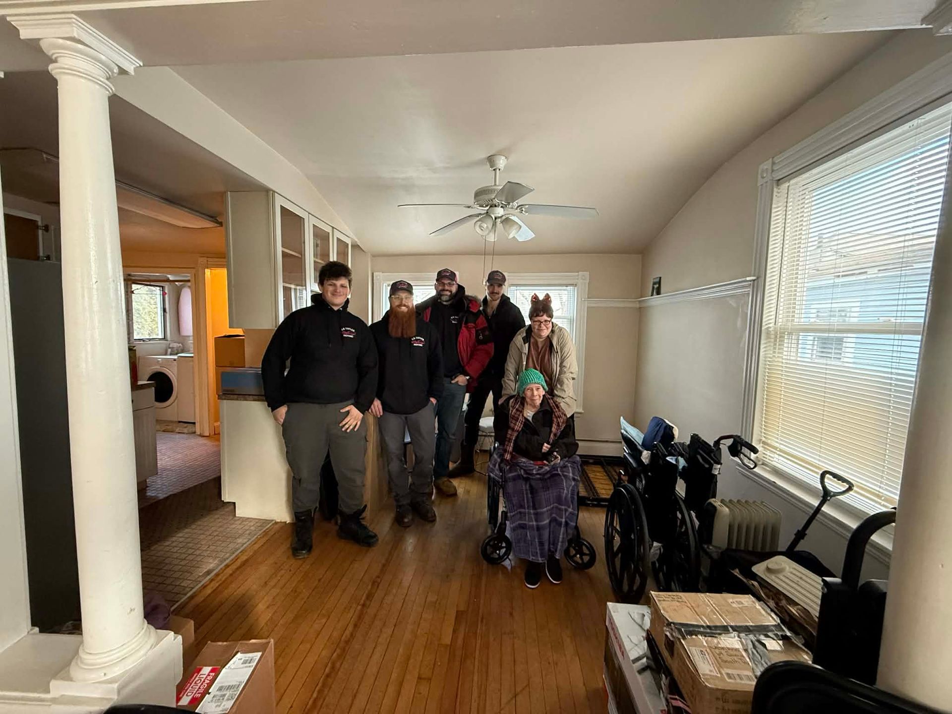 picture of moving team with a senior client and her daughter