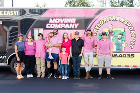 Moving crew and family in front of the moving trailer