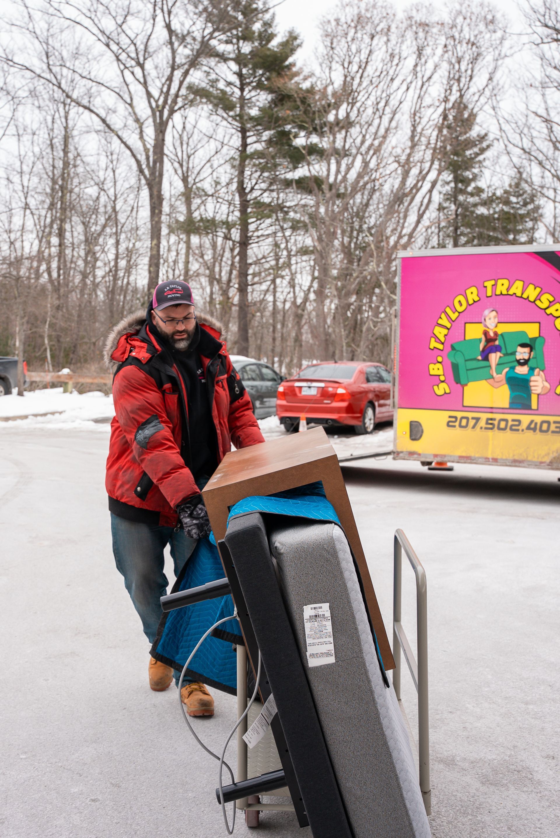 Mover pushing cart of furniture