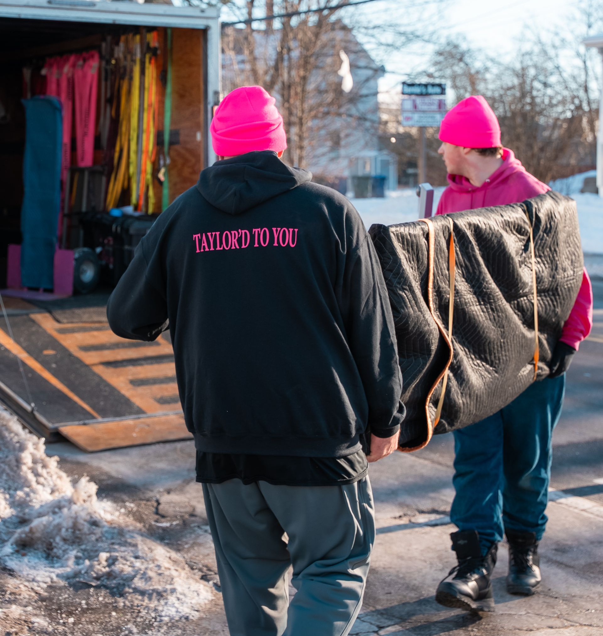 two movers carrying furniture