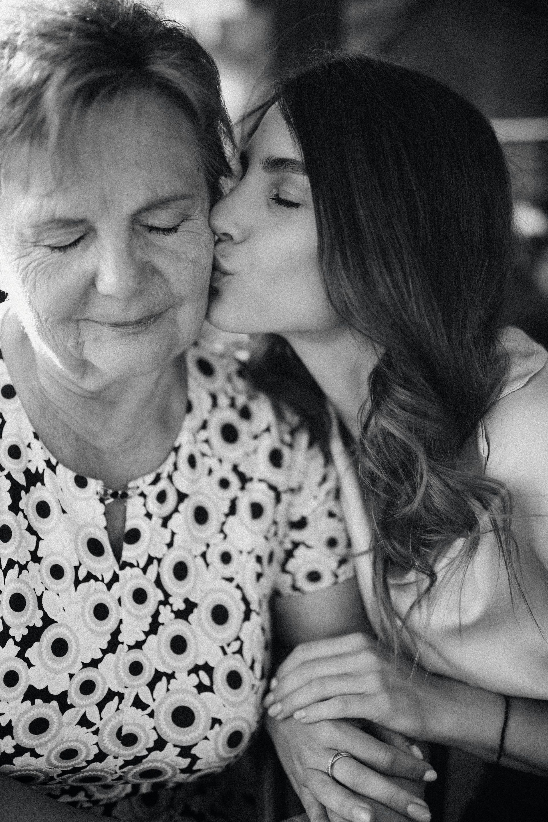 daughter kissing her older mother's cheek