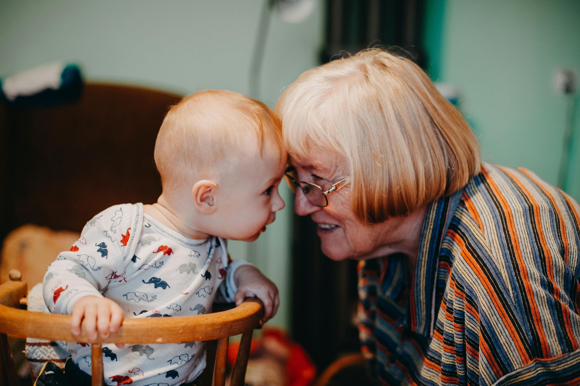 grandmother and grandchild touching heads to each other