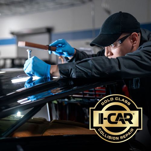 Auto glass technician repairing a windshield with a suction tool and hammer, I-CAR badge visible