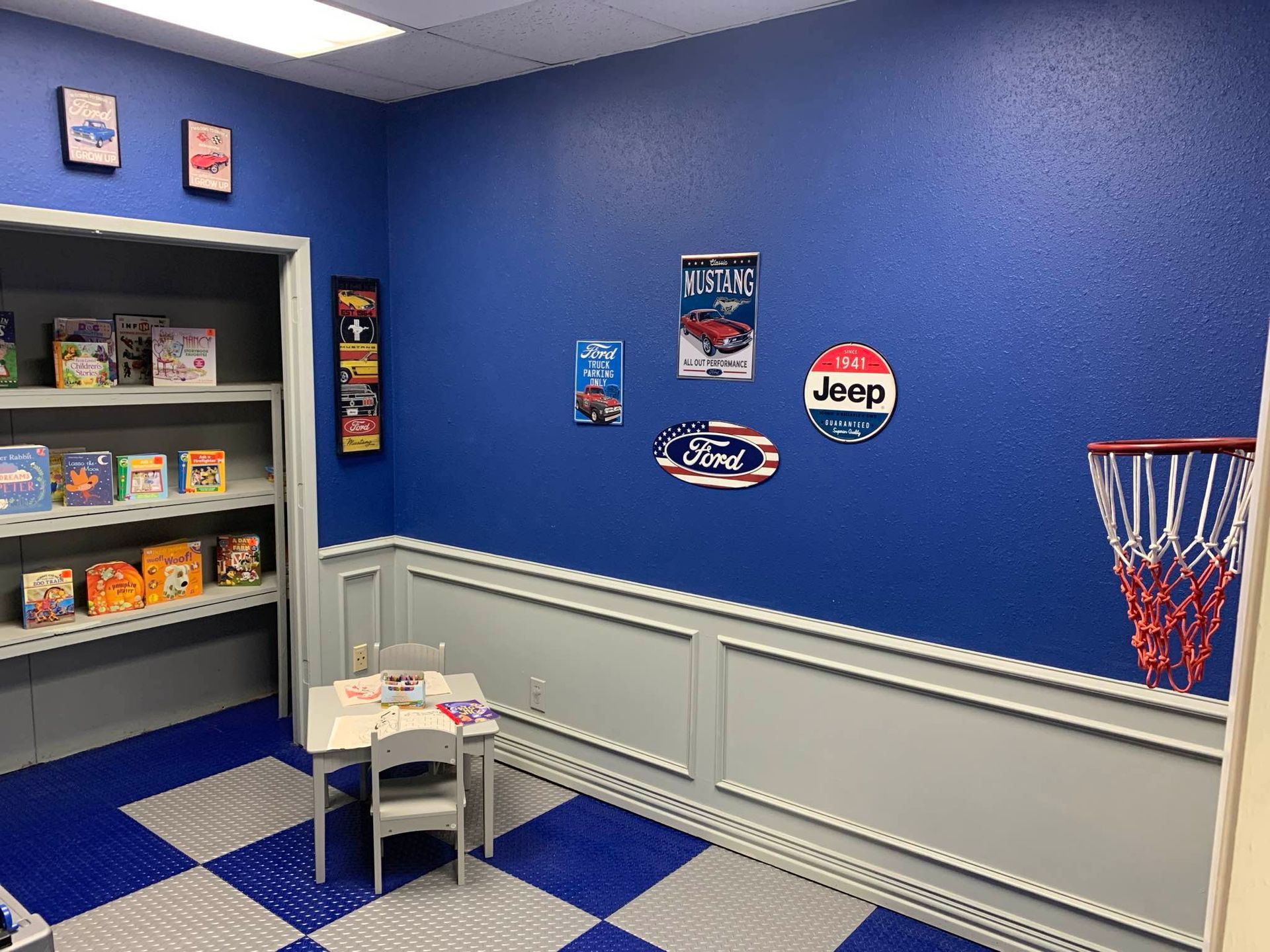 A room with a table and chairs and a basketball hoop.