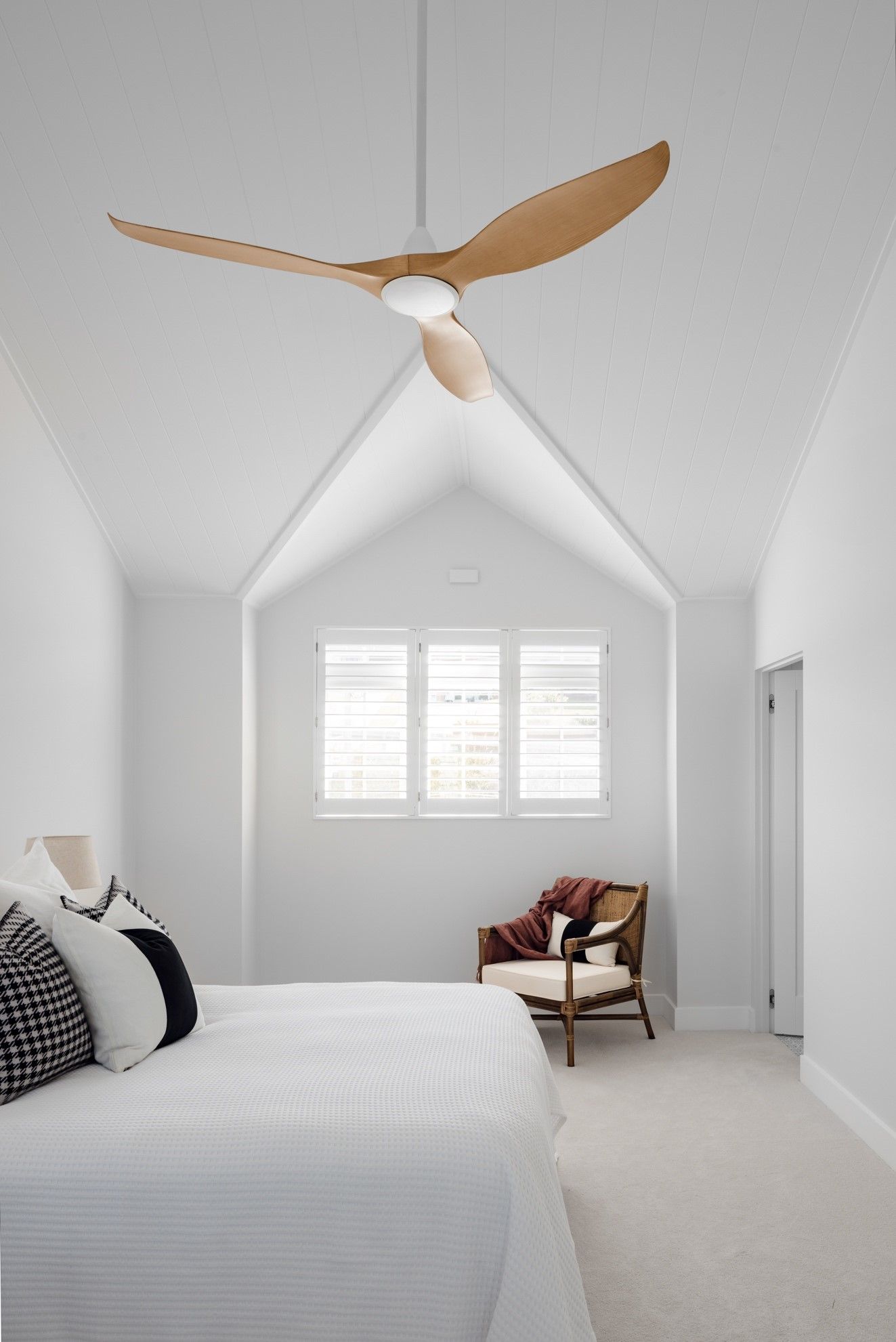 A Bedroom With a Bed, Chair and Ceiling Fan — QBC Constructions In Gables, NSW
