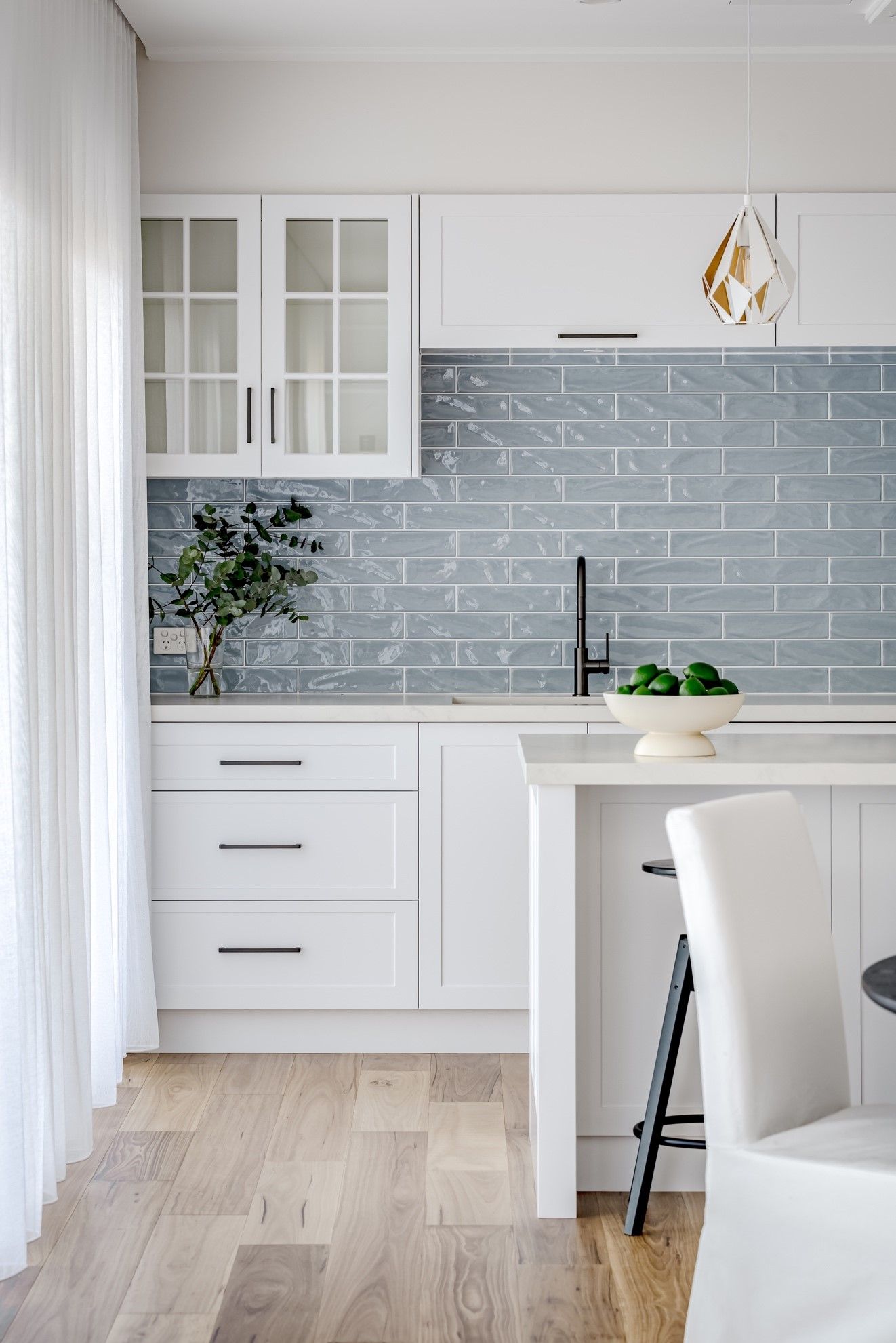 A Kitchen With White Cabinets, a Sink, and a Wooden Floor — QBC Constructions In Gables, NSW