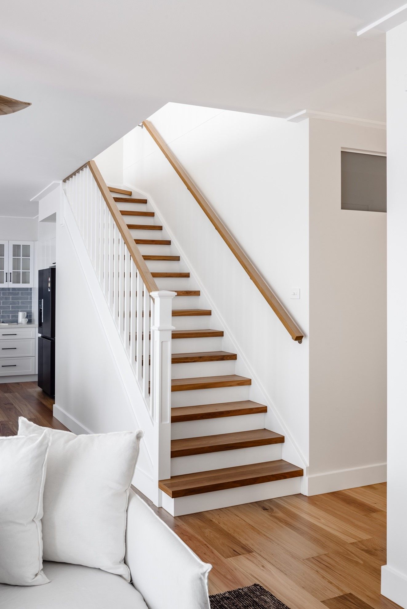 A Living Room With a Staircase Leading Up to the Second Floor — QBC Constructions In Gables, NSW