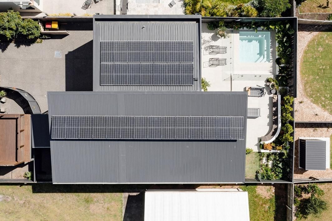 An Aerial View Of A House With Solar Panels On The Roof — QBC Constructions In Werri Beach, NSW