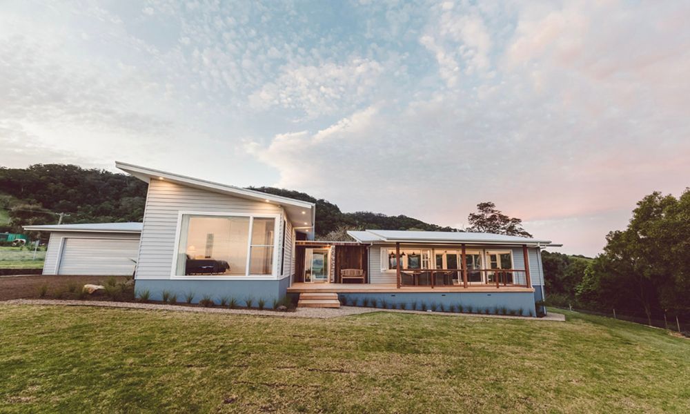 A Large House is Sitting on Top of a Lush Green — QBC Constructions In Willow Vale, NSW