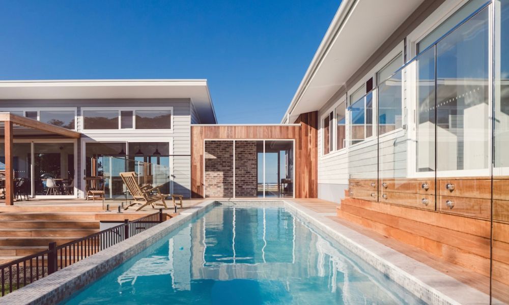 A Large House With a Swimming Pool in Front — QBC Constructions In Willow Vale, NSW