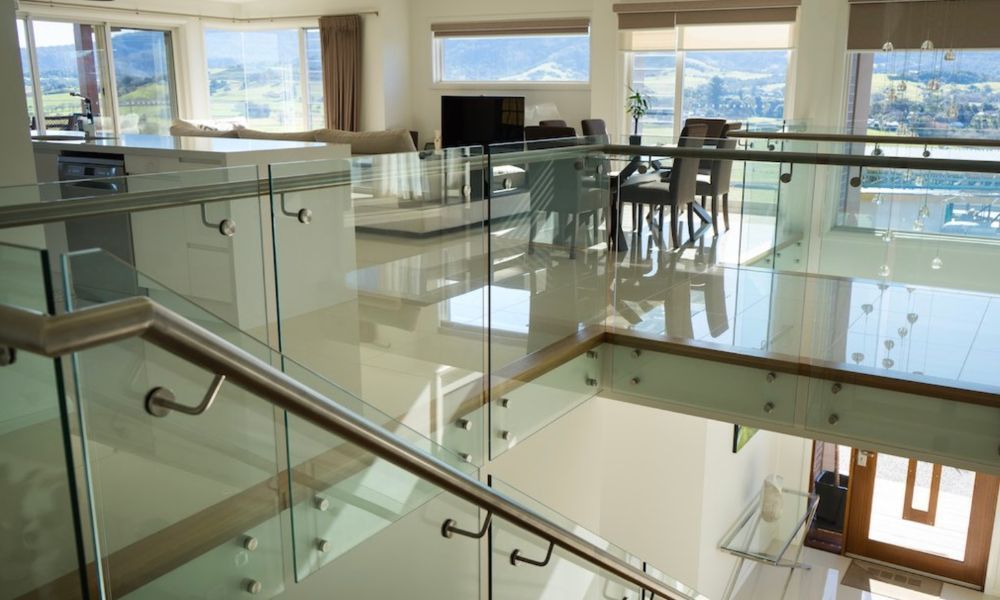 A Staircase in a House With a Glass Railing Leading — QBC Constructions In Gerringong, NSW