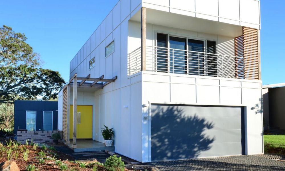 A White House With a Yellow Door and a Garage — QBC Constructions In Gerringong, NSW