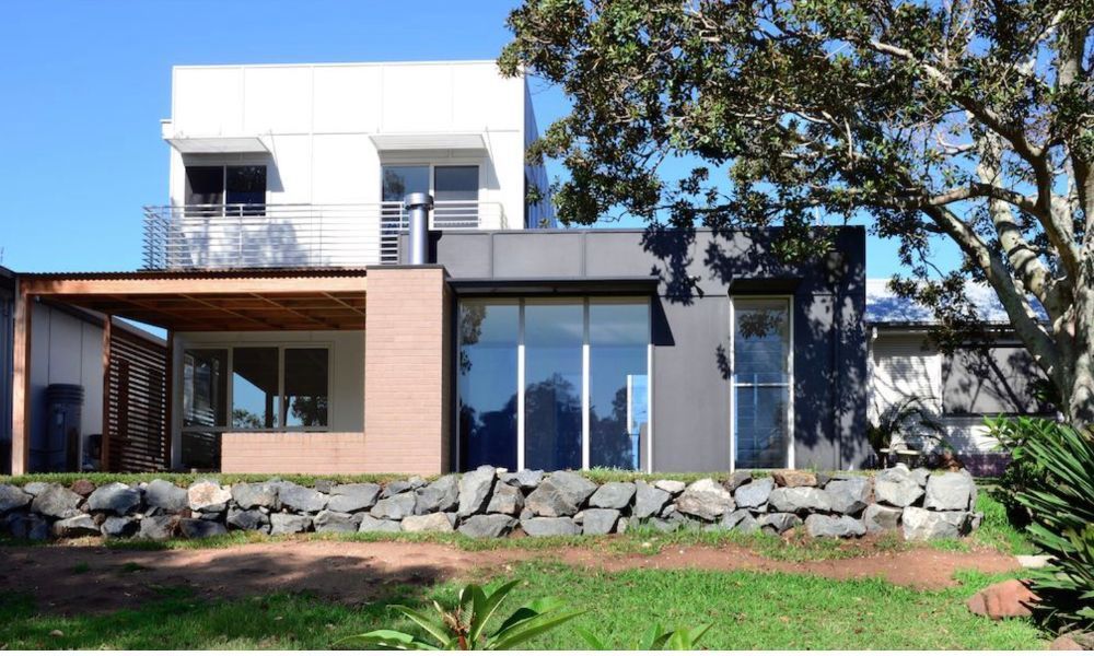 A House With a Lot of Windows and a Tree in Front of It — QBC Constructions In Gerringong, NSW