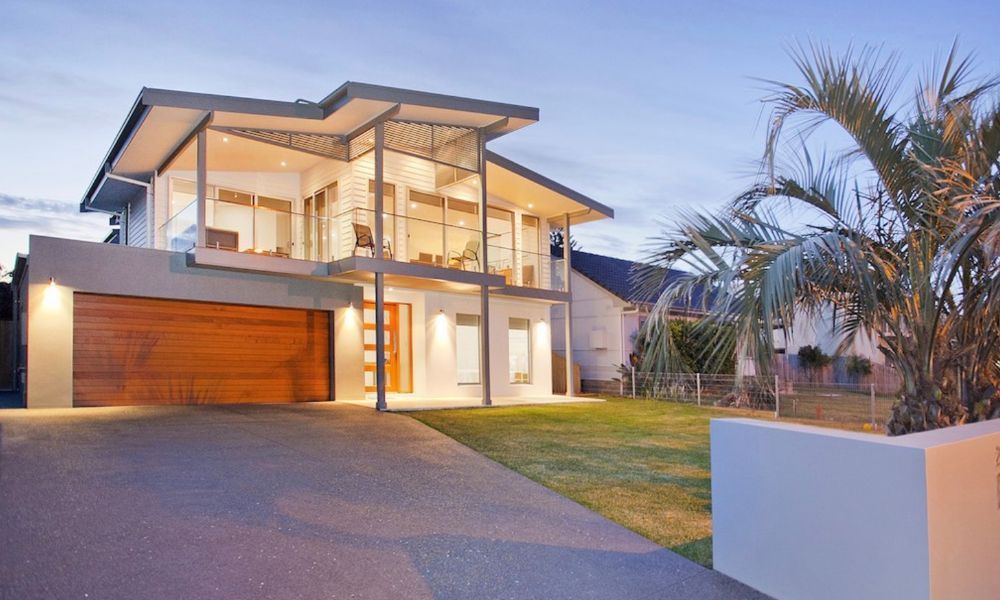 A Modern House With a Lot of Windows — QBC Constructions In Werri Beach, NSW