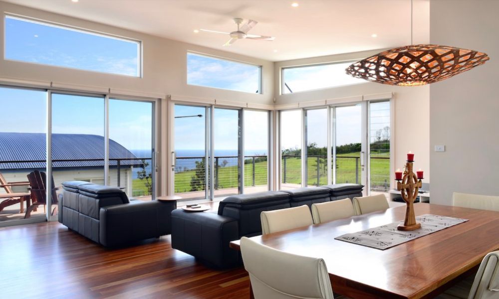 A Living Room With a Dining Table and a Couch — QBC Constructions In Gerringong, NSW