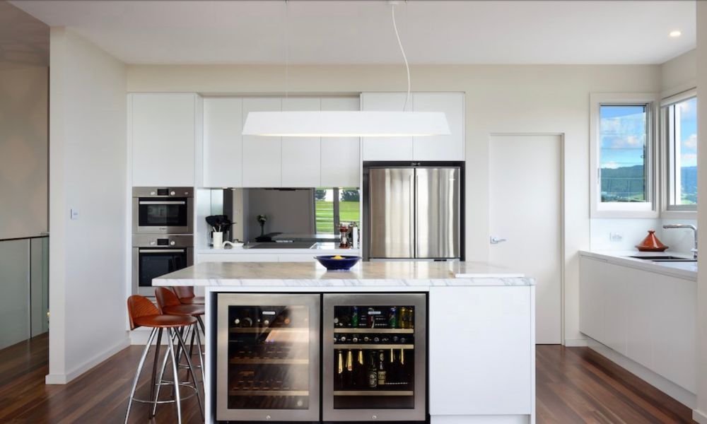A Kitchen With White Cabinets and Stainless Steel Appliances — QBC Constructions In Gerringong, NSW