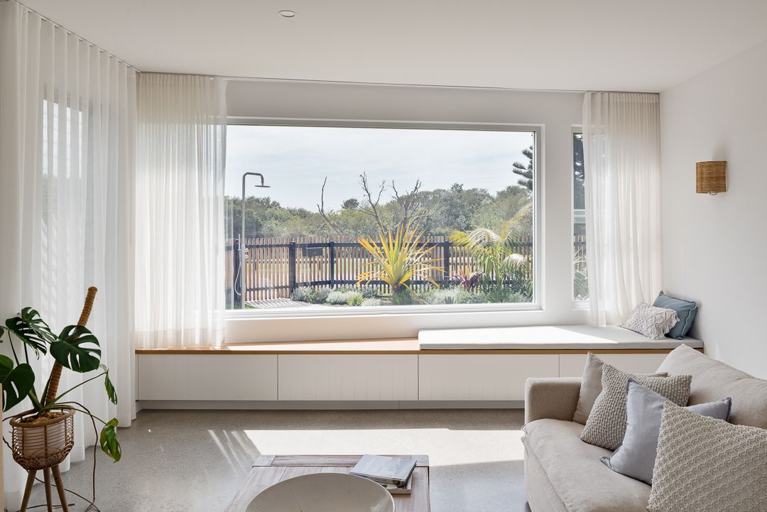 A Living Room With a Couch and a Large Window — QBC Constructions In Werri Beach, NSW