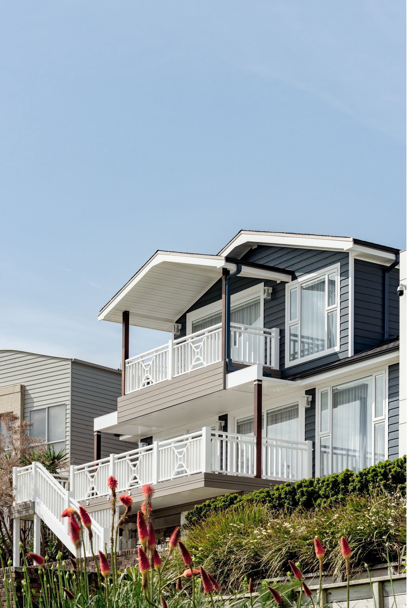 A Large House With a Balcony is Sitting on Top of a Hill — QBC Constructions In Gables, NSW