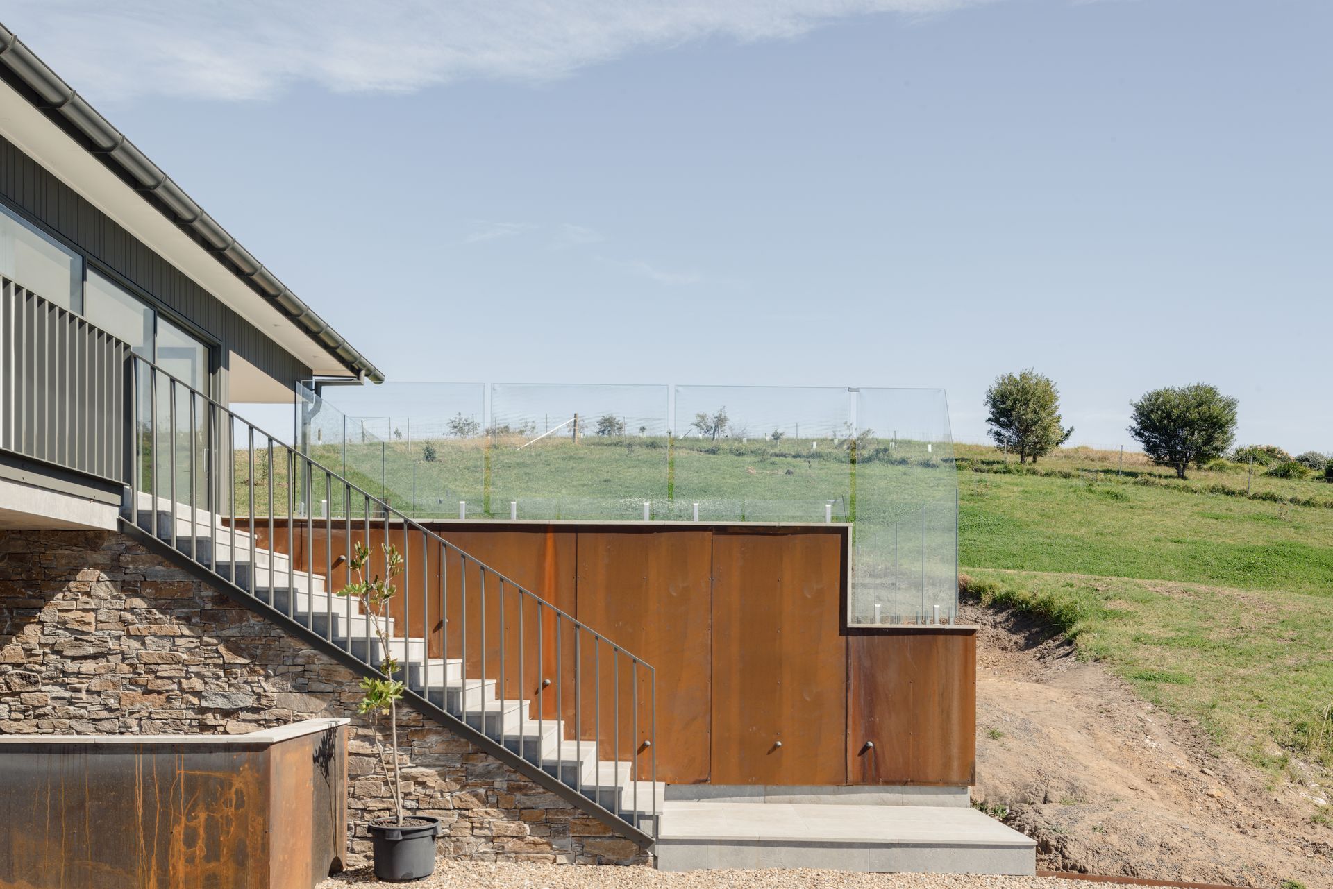 A House With a Balcony and Stairs Leading Up to It — QBC Constructions In Seven Mile Beach, NSW