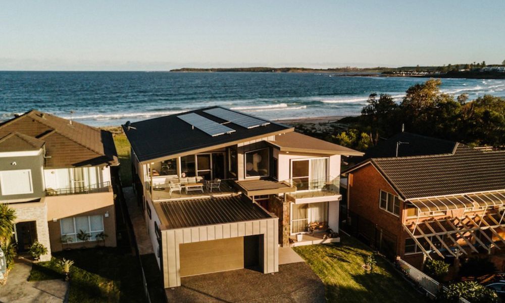 An Aerial View of a Row of Houses Next to the Ocean — QBC Constructions In Shellharbour, NSW