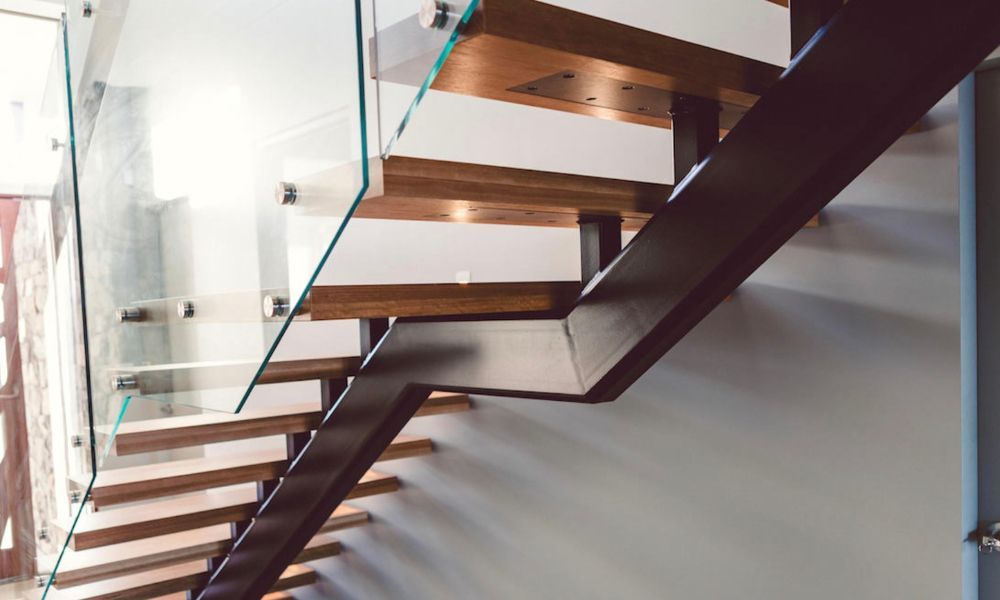 A Modern Staircase With Wooden Steps and a Glass Railing — QBC Constructions In Shellharbour, NSW