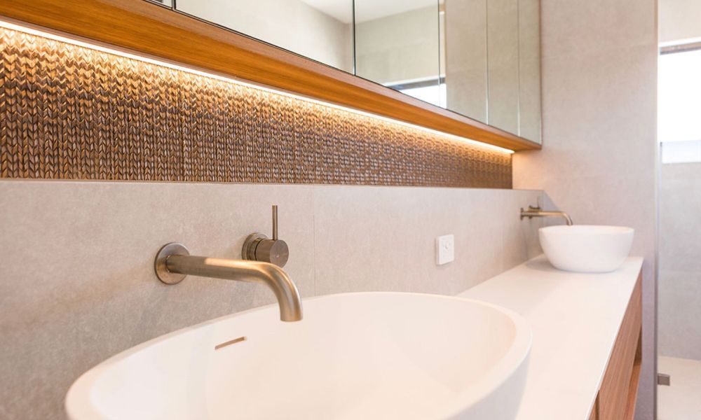 A Bathroom With Two Sinks and a Mirror — QBC Constructions In South Coast, NSW