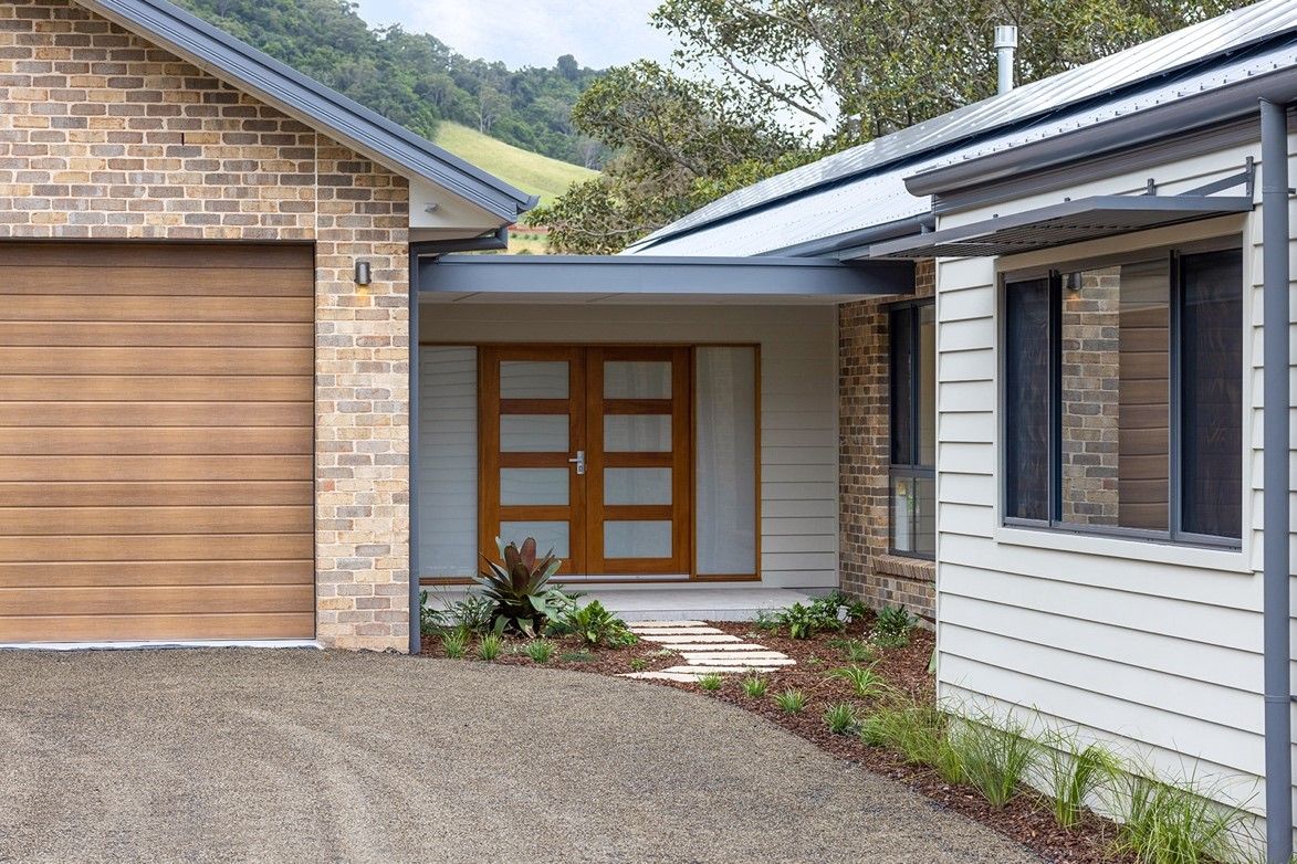 A House With a Garage Door and a Driveway — QBC Constructions In Curramore, Queensland