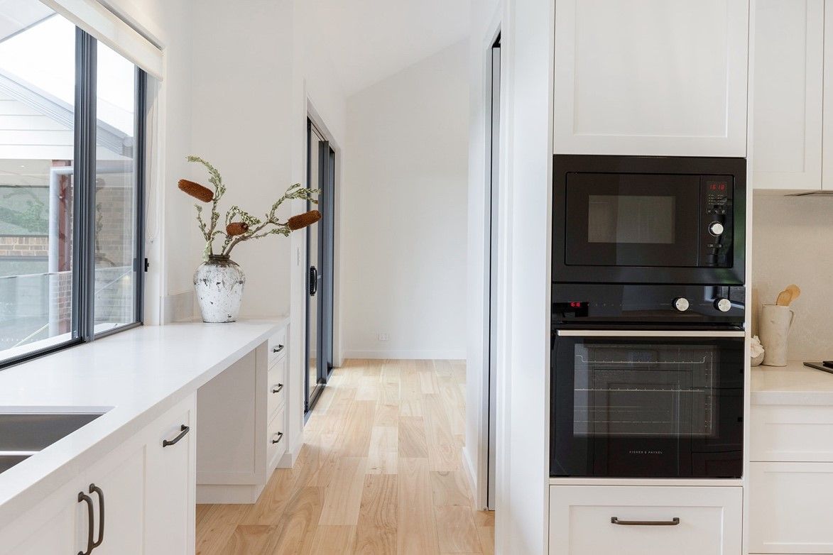 A Kitchen With White Cabinets — QBC Constructions In Curramore, Queensland