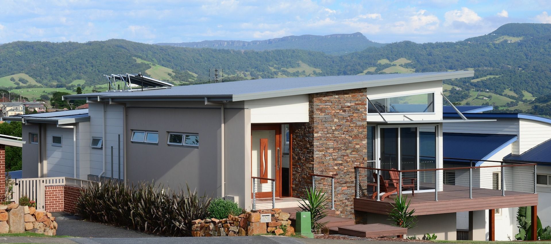 A modern house with mountains in the background
